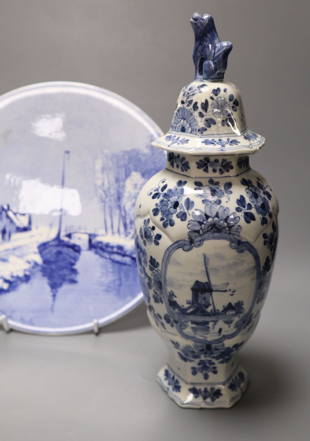 A delftware vase, 22cm, delft vase and a painted wall plate, 26cm